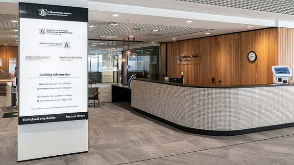 A photo of a main directory board near the reception desk in the lobby of a government building.